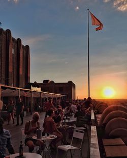 People sitting on chair at sunset