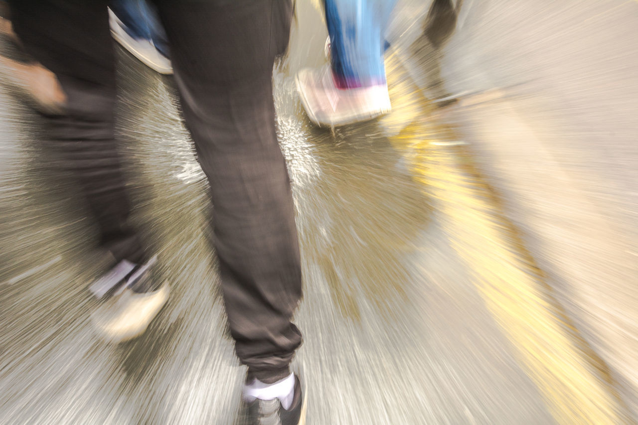 LOW SECTION OF PEOPLE WALKING ON VEHICLE