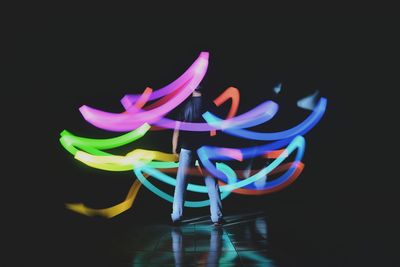 Close-up of multi colored flower over black background