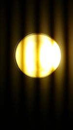 Close-up of lit light bulb