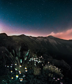 Scenic view of mountains against sky at night