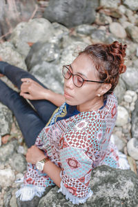 Young woman sitting on rock