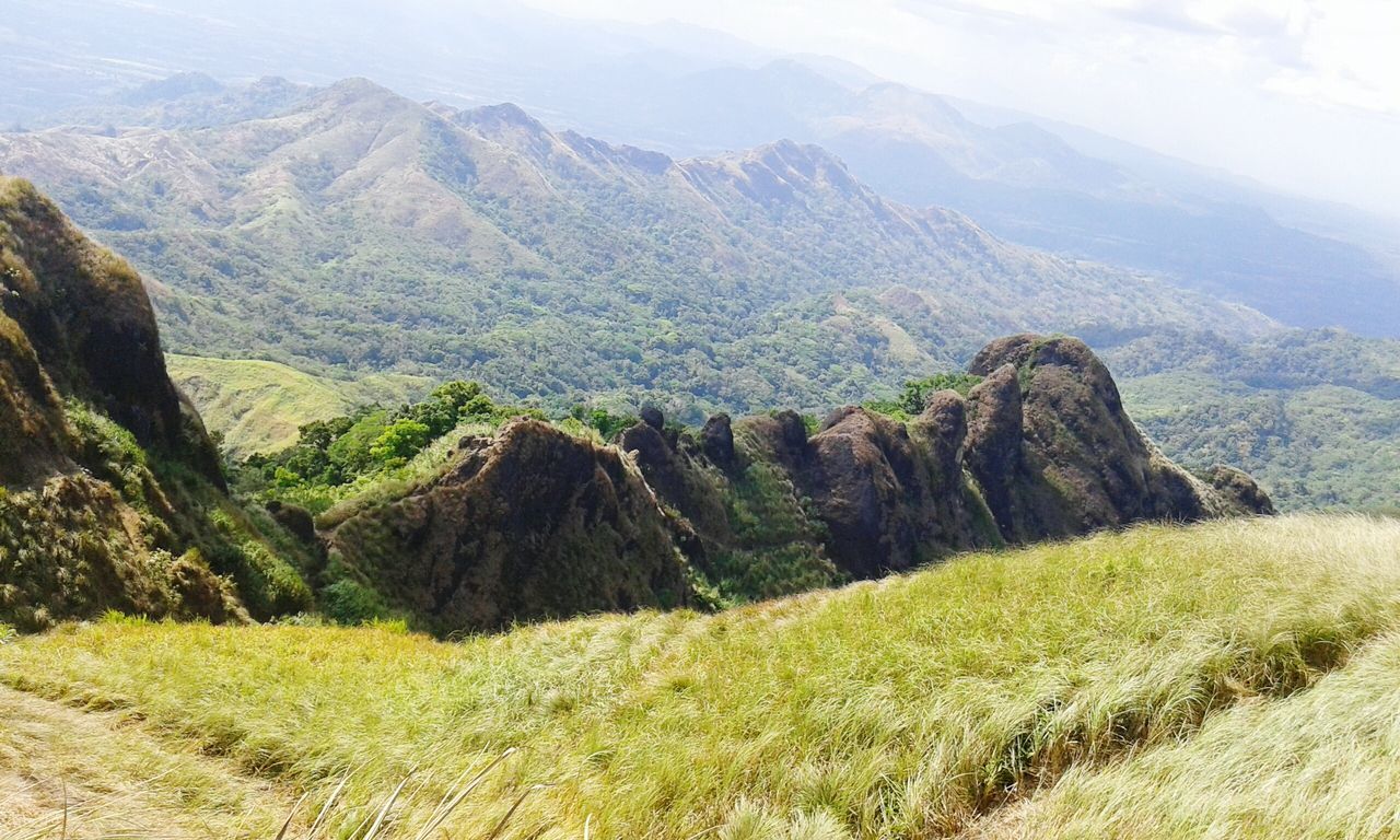 mountain, tranquil scene, landscape, tranquility, scenics, grass, beauty in nature, mountain range, nature, sky, non-urban scene, green color, field, plant, growth, idyllic, remote, day, hill, outdoors