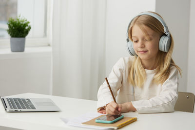 Young businesswoman working at table