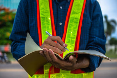 Close-up of man holding book