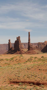 Rock formations on landscape against sky