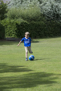 Boy playing soccer at park
