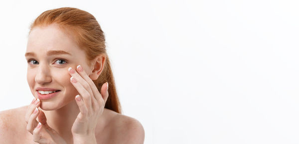 Portrait of young woman against white background