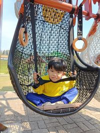 High angle view of cute boy sitting on slide