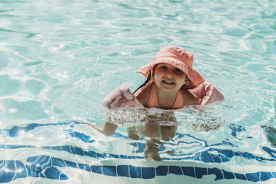 Portrait of young woman in swimming pool