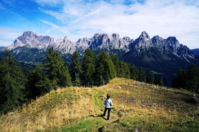 Rear view of man walking on mountain