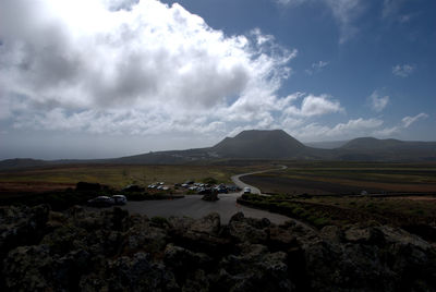 Scenic view of mountains against cloudy sky