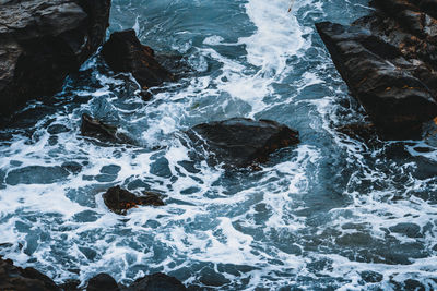 High angle view of rocks in sea