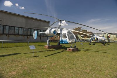 Low angle view of people on field against sky