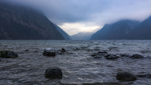 Scenic view of sea and mountains against sky