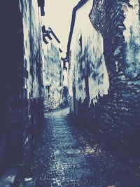 Narrow alley amidst buildings in city