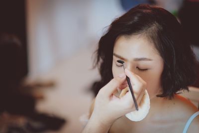 Midsection of woman making face at home