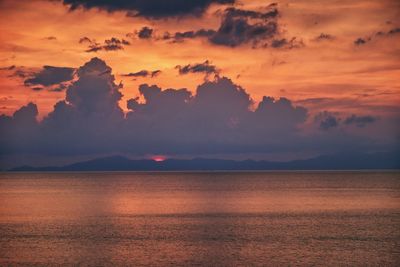 Scenic view of sea against romantic sky at sunset