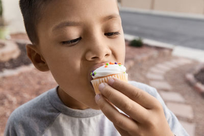 Close-up of boy eating cupcake