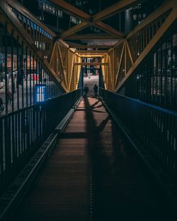 People on footbridge at night