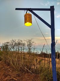 Yellow flag on field against sky at sunset