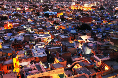 High angle view of illuminated town at dusk