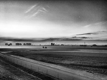 Scenic view of field against cloudy sky