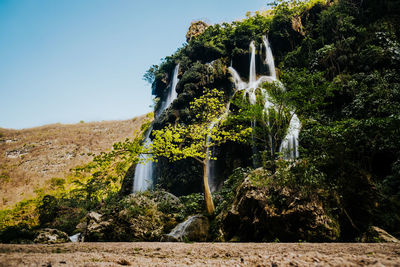 Scenic view of waterfall against clear sky