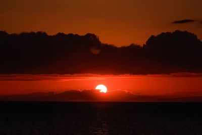 Scenic view of sea against romantic sky at sunset