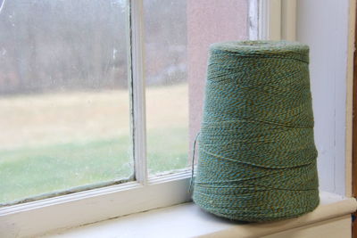 Close-up of spool on window sill