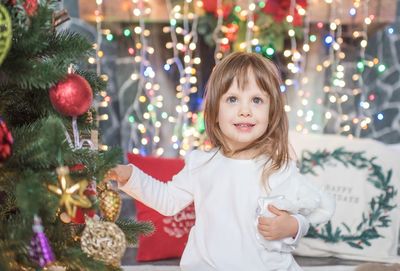 Portrait of girl under christmas tree