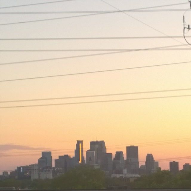 building exterior, architecture, sunset, built structure, city, power line, cityscape, cable, skyscraper, orange color, sky, connection, silhouette, no people, modern, urban skyline, outdoors, office building, building, electricity pylon