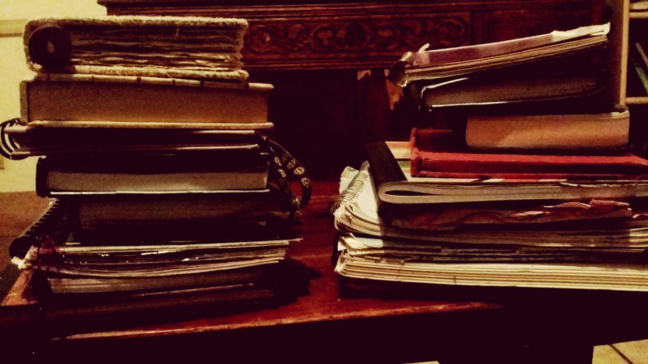 STACK OF OLD BOOKS ON TABLE