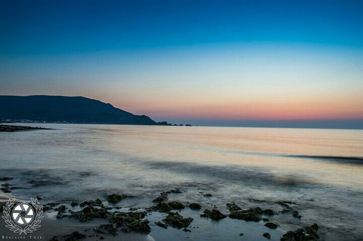 water, sea, scenics, tranquil scene, beauty in nature, tranquility, clear sky, beach, copy space, horizon over water, nature, shore, sunset, idyllic, blue, wave, sky, dusk, coastline, outdoors