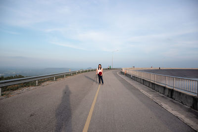 Rear view of man on road against sky