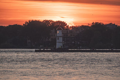 Scenic view of lake against orange sky