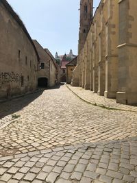 Footpath amidst old buildings in city