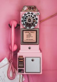 Text on pink pay phone