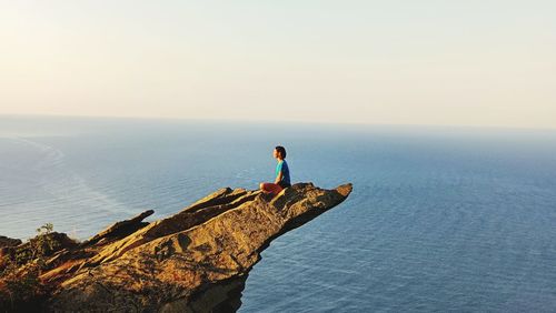 Man looking at sea against sky