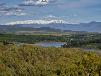 Scenic view of lake and mountains against sky