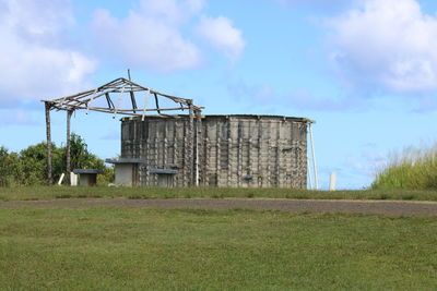 Built structure on field against sky