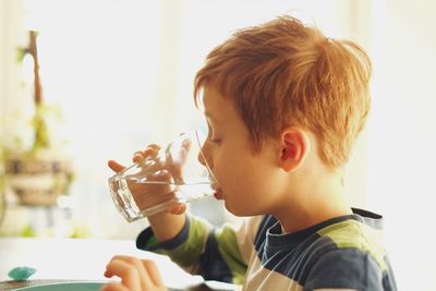 Close-up of boy drinking water