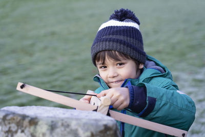 Smiling cute boy holding arrow
