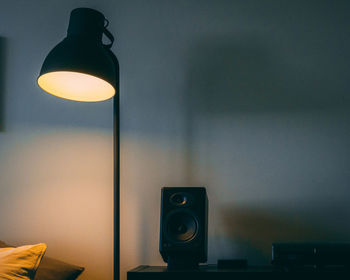 Close-up of illuminated light bulb on wall at home