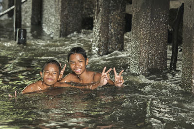 Portrait of happy children in water