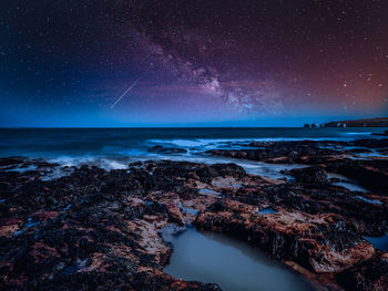 Scenic view of sea against sky at night