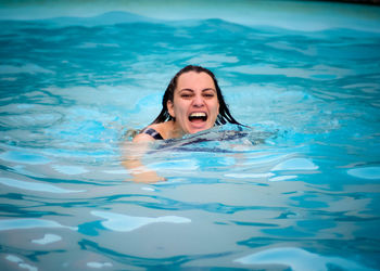 Portrait of woman swimming in pool