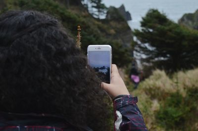 Cropped image of person holding smart phone