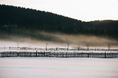 Scenic view of frozen lake against sky during winter