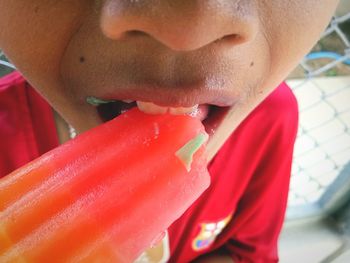 Close-up of boy drinking ice cream